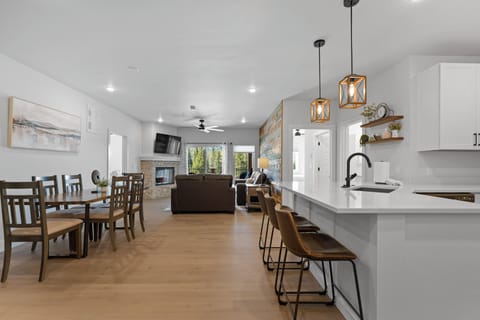 Your open-plan retreat blends modern style and warmth, with a chef's kitchen, cozy fireplace, and sunlit spaces perfect for gathering, cooking, and unwinding together.