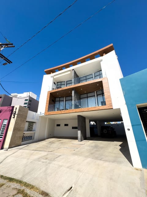 Modern three-story home with spacious balconies and parking