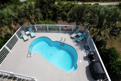 Aerial view of the private pool deck surrounded by tropical landscaping and palm trees.