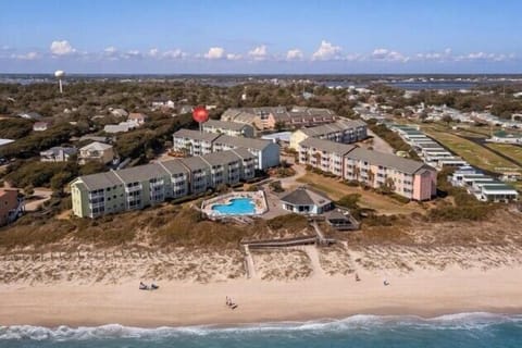Aerial from beach- Oceanside resort living at Pebble Beach - pools, beach access, and sweeping coastal views all in one spectacular setting.