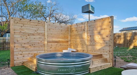 Cool off in the private cowboy pool surrounded by a cedar deck with built-in seating and string lights.