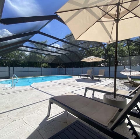 Private Screened-In Pool with loungers