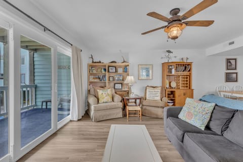 Relax in your coastal living room with nautical touches, cozy seating, and French doors opening to your private balcony.