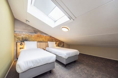 Drift off comfortably beneath skylights in a quiet loft.