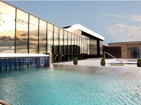 Dive into serene outdoor swims with sleek modern surroundings.