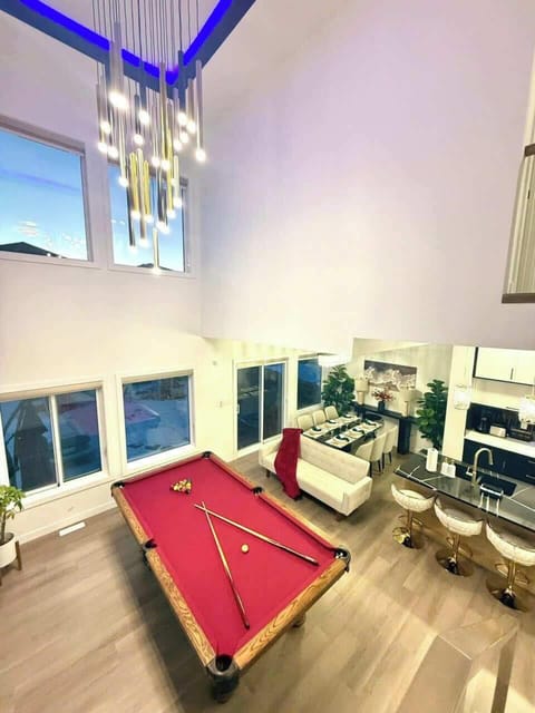 Spacious game room with pool table and modern lounge seating