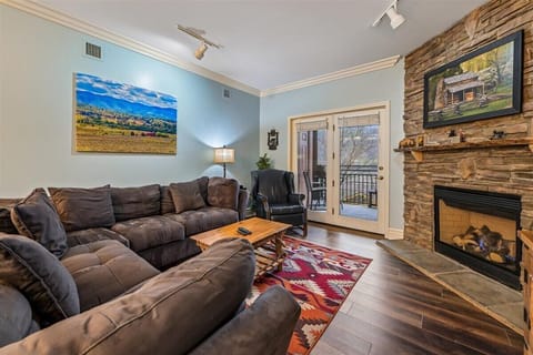 Sink into plush sectional seating by your stone fireplace, where rustic charm meets modern comfort in your mountain retreat.