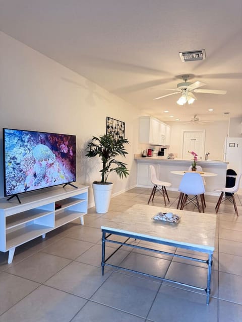 The living room and dining area are fully integrated into the kitchen