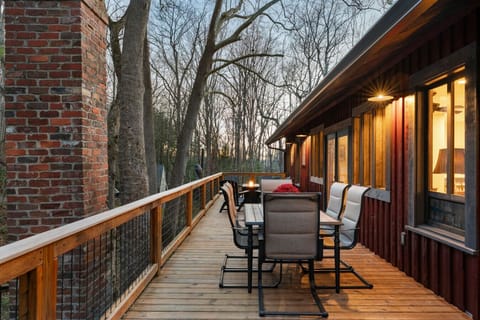 Beautiful deck for outdoor dining and fire table by the creek