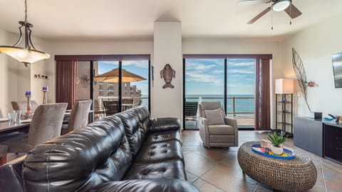 A leather sofa in living room. 2 doors access balcony