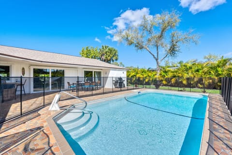 A private pool with step entry and a screened safety enclosure for peace of mind.
