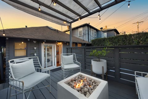Private patio with lounge seating, string lights, and a firepit for relaxed evenings outdoors.
