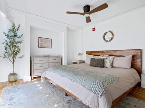 Enjoy a spacious, stylish bedroom in Asheville featuring a king bed, contemporary décor, and abundant natural light.