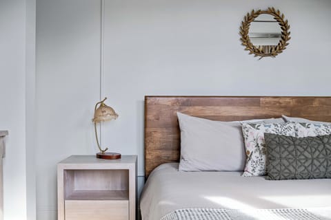 Cozy bedroom corner with soft lighting and clean, modern design for a comfortable stay.