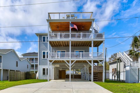 Multi-level coastal home with expansive decks and covered parking in a quiet residential neighborhood.