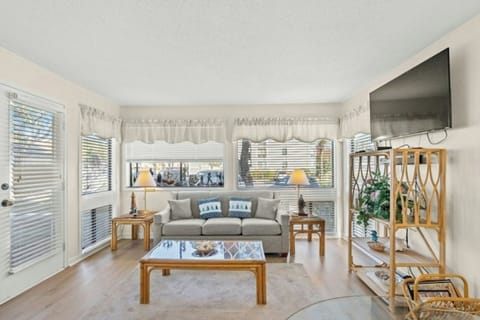 The magnificent windows allow the sun to shine into the living room.