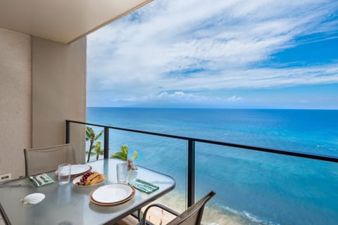 Oceanfront lanai with outdoor dining, showcasing panoramic Pacific Ocean views.