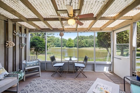 Pondfront screened porch offers peaceful outdoor dining and relaxing views.