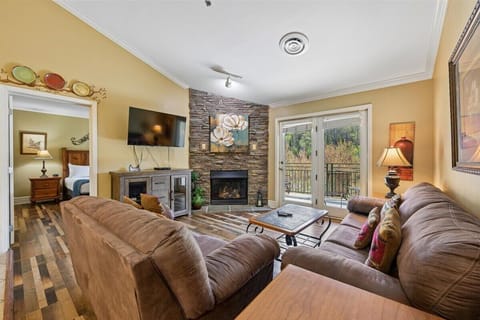 Curl up on plush sofas by your crackling stone fireplace while nature unfolds beyond your private balcony doors.