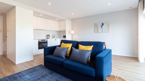 Bright and airy living area with a cozy sofa, perfect for unwinding. The light décor and colorful accents make it feel fresh and inviting. #CozyVibes #ModernLiving