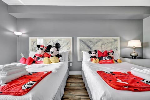 Two queen beds for 4 guests in the bedroom! Decorated with Disney toys and blankets!
