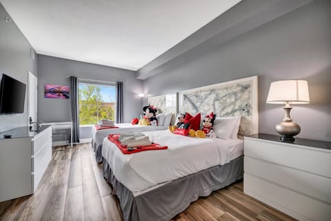 Two queen beds for 4 guests in the bedroom! Decorated with Disney toys and blankets!