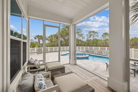 Relax in your screened porch with pool views, where comfortable seating and tropical breezes create the perfect retreat.