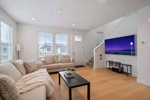 Living Room: Comfortable living room with plush seating, smart TV, and a bright, welcoming feel.