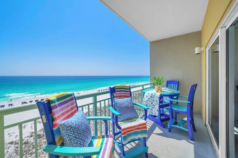 Your private beachfront balcony awaits with stunning sea views and colorful dining furniture for memorable meals overlooking paradise.