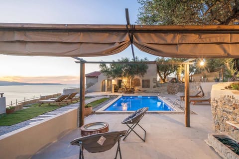 outdoor garden : private swimming pool ,sun lounge relaxation area ,open views from poolside , designed for all-day outdoor living, uninterrupted views 
