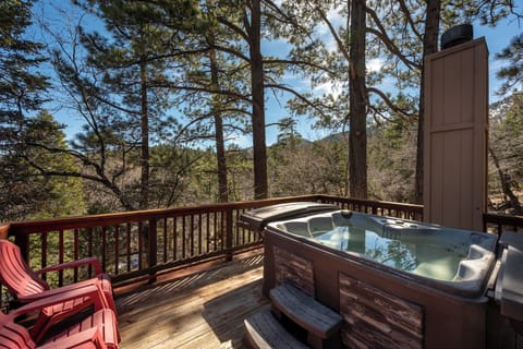 Soak in your private hot tub while surrounded by towering pines and rolling hills, creating the perfect mountain retreat.