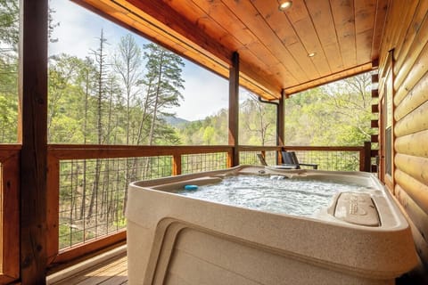 Soak in your private hot tub while surrounded by forest views from this peaceful covered deck.
