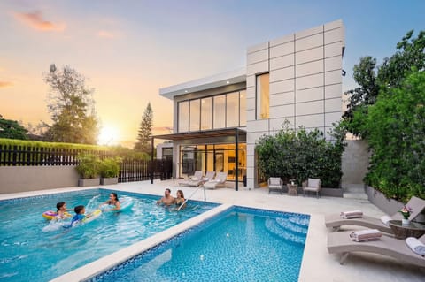 Outdoor oasis with a dual-level pool, lounge seating, and seamless indoor-outdoor flow for entertain