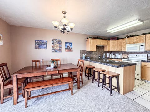 pacious dining area with breakfast bar and open kitchen, perfect for gathering and entertaining