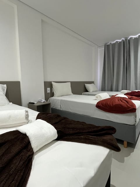 Deluxe Triple Room, 1 Bedroom | Desk, laptop workspace, free WiFi, bed sheets