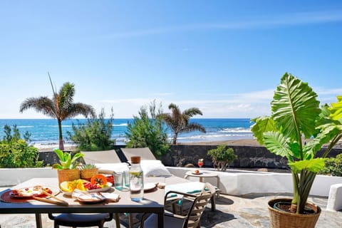 Terrace with outdoor dining table and sun loungers.