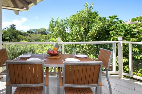 Enjoy a tropical al fresco meal surrounded by lush greenery and vibrant island vibes on this serene lanai retreat. GCH-134