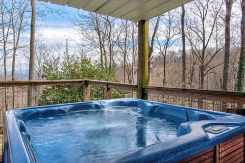Soak in your private hot tub while enjoying forest views from this peaceful covered deck.