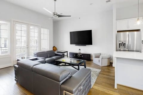 Living Room with large TV and access to a private balcony.