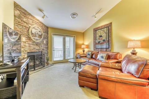 Sink into rich leather seating by your stone fireplace, where warm golden walls and rustic accents create the perfect retreat.