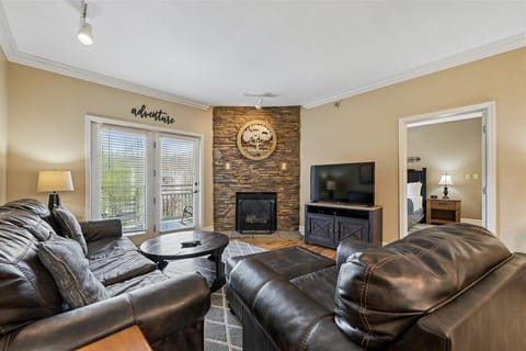 Cozy up in your spacious living room, where leather seating and a stone fireplace create the perfect atmosphere for relaxation.