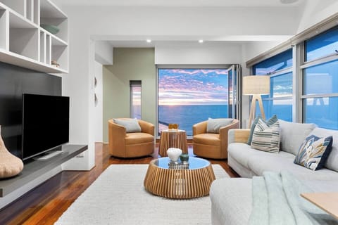 Settle into the living area as sea breezes drift through bifold doors and the horizon becomes part of your everyday rhythm.