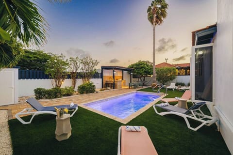 Sunset over your private backyard and poolside lounge.