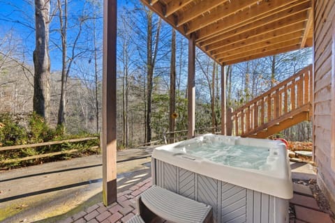 Relax in the bubbling hot tub as you enjoy the peaceful ambiance of the surrounding trees.