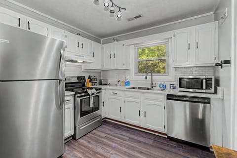 Your fully equipped kitchen features modern stainless steel appliances, crisp white cabinets, and everything you need to prepare your favorite meals.