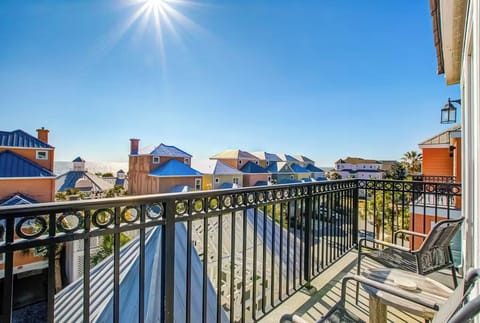 Step onto your private balcony and soak in stunning views of colorful beach houses beneath brilliant blue skies.