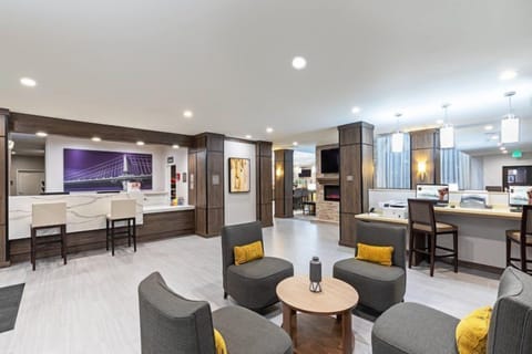 Relax in the inviting lobby, designed for comfort with stylish seating and warm lighting.