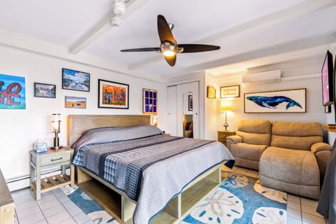 Bright king suite with artful decor, recliner sofa, AC and smart TV