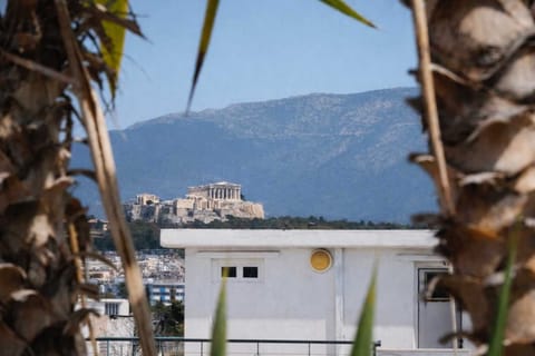 Terrace view toward the Acropolis and Athens skyline.