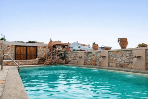 Private pool with surrounding stone walls and open sky, offering a calm space for swimming and relaxing.